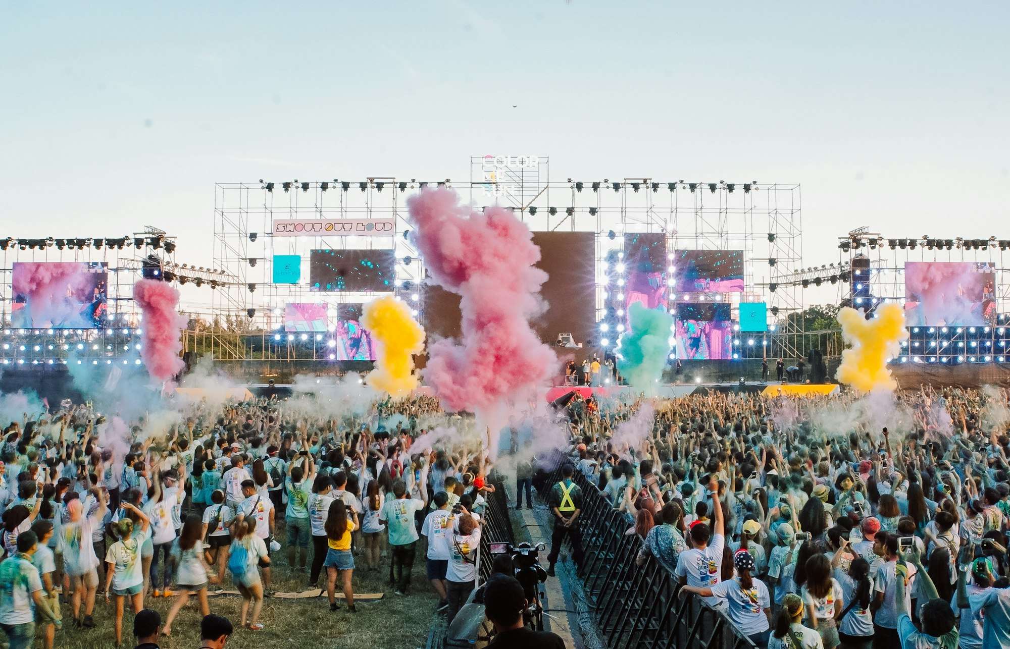 People gathering at a summer field festival